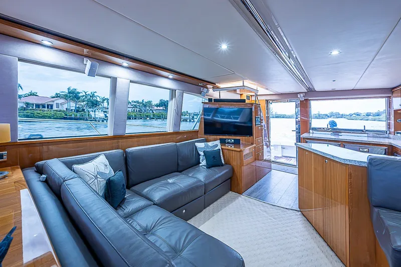 Slide: The Image of Luxurious interior of 2009 Riviera 58 Flybridge yacht with modern furnishings and scenic views. - 16