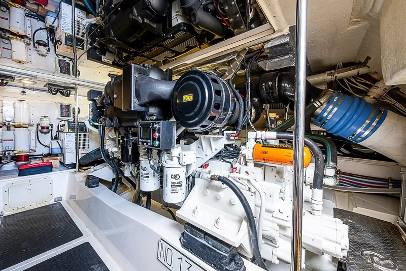 Slide: The Image of Engine room of 2009 Riviera 58 Flybridge yacht, showcasing mechanical components and systems. - 57