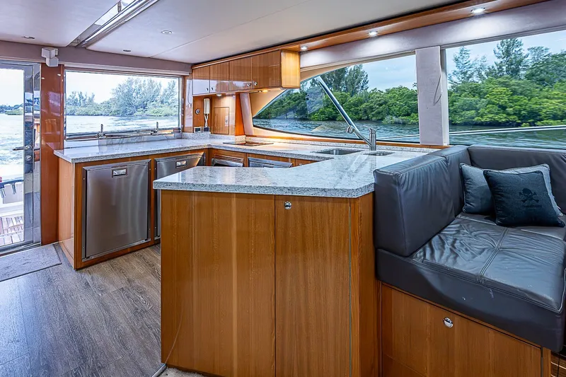 Slide: The Image of Luxurious interior of 2009 Riviera 58 Flybridge yacht with modern kitchen and seating area. - 13