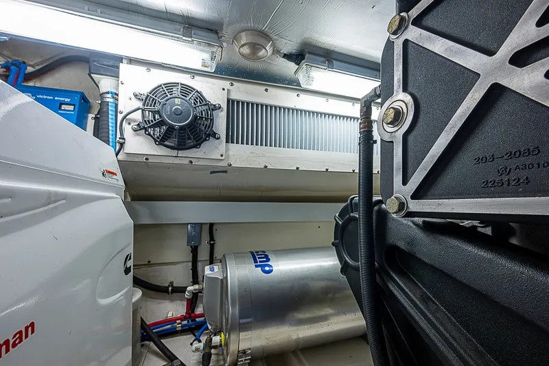 Slide: The Image of Engine room of 2009 Riviera 58 Flybridge yacht, showcasing mechanical components and equipment. - 55