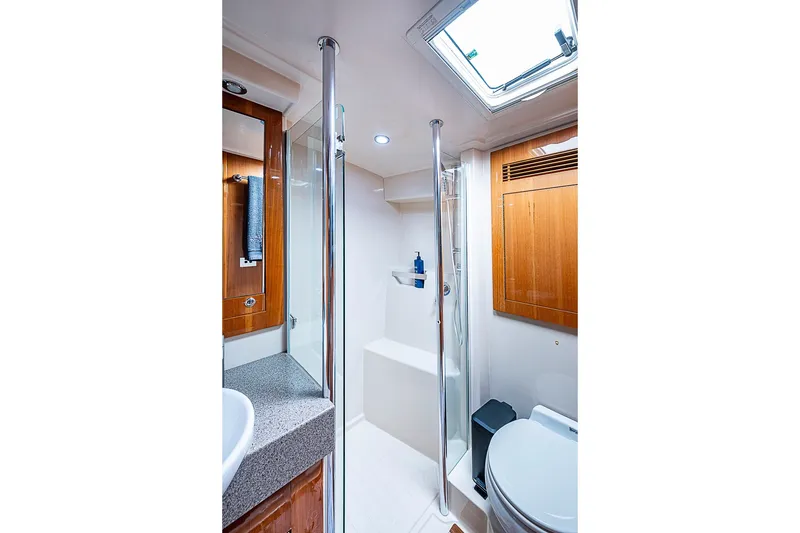 Slide: The Image of Luxurious bathroom in 2009 Riviera 58 Flybridge yacht with modern fixtures and wood accents. - 32