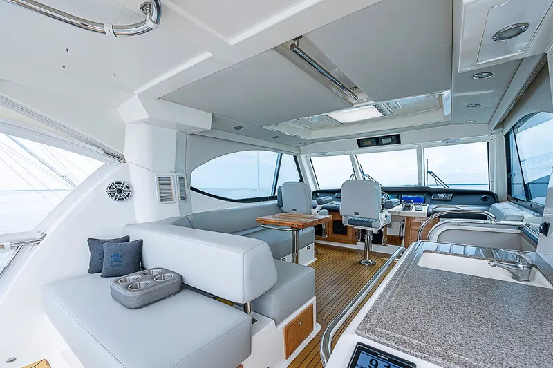 Slide: The Image of Luxurious interior of 2009 Riviera 58 Flybridge yacht with modern seating and navigation area. - 69