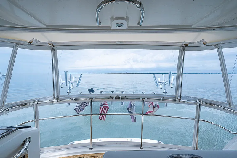 Slide: The Image of Flybridge view from 2009 Riviera 58 yacht, overlooking calm ocean waters. - 74
