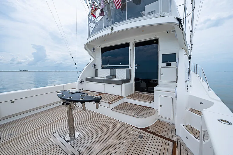 Slide: The Image of 2009 Riviera 58 Flybridge yacht deck with seating and fishing rod holders. - 80