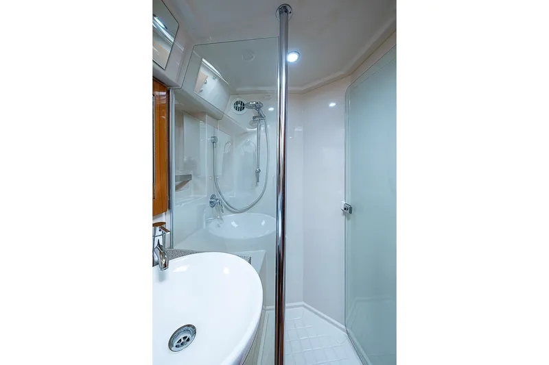 Slide: The Image of Luxurious bathroom in 2009 Riviera 58 Flybridge yacht with modern fixtures and glass shower. - 49