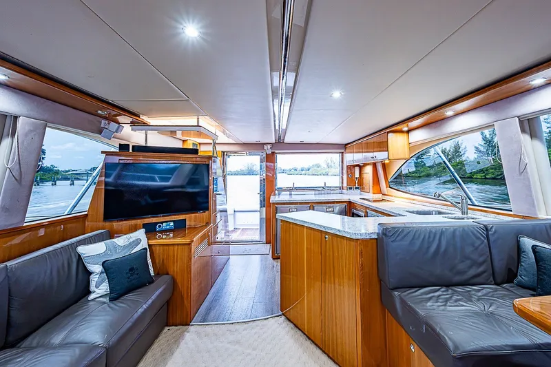 Slide: The Image of Luxurious interior of 2009 Riviera 58 Flybridge yacht with modern furnishings and large windows. - 14