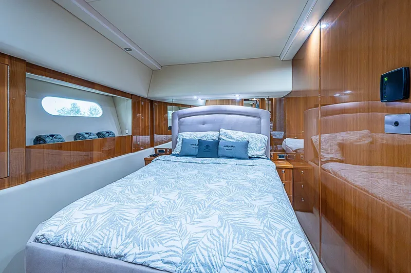 Slide: The Image of Luxurious bedroom interior of 2009 Riviera 58 Flybridge yacht with elegant wood paneling. - 30