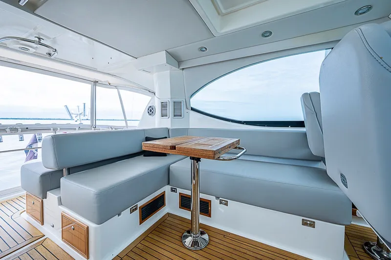 Slide: The Image of Luxurious interior of 2009 Riviera 58 Flybridge yacht with sleek seating and wooden table. - 65