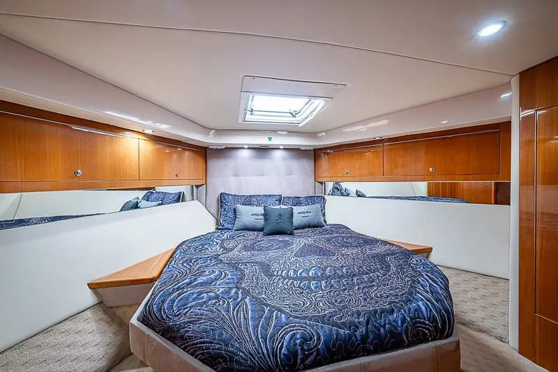 Slide: The Image of Luxurious bedroom interior of 2009 Riviera 58 Flybridge yacht with elegant bedding and wood accents. - 48