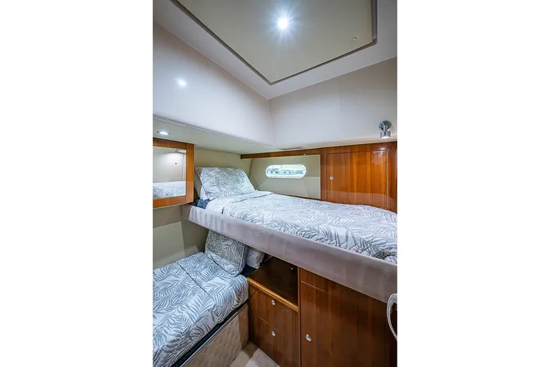 Slide: The Image of Luxurious 2009 Riviera 58 Flybridge cabin with cozy bunk beds and elegant wood finish. - 39