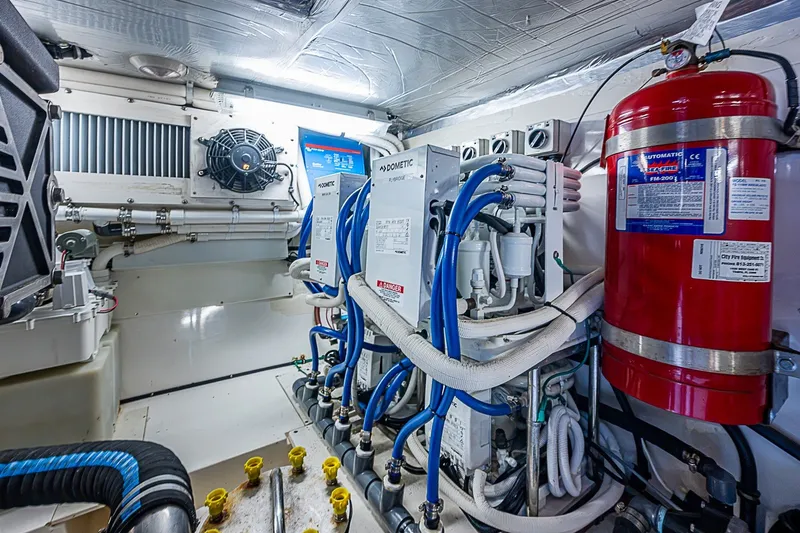 Slide: The Image of Engine room of 2009 Riviera 58 Flybridge yacht with fire extinguisher and Dometic systems. - 59
