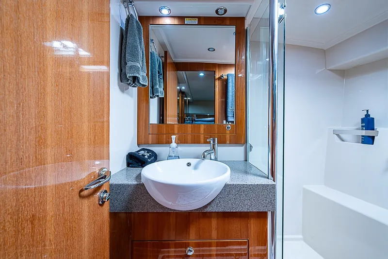 Slide: The Image of Luxurious bathroom in 2009 Riviera 58 Flybridge yacht with modern fixtures and wooden accents. - 35