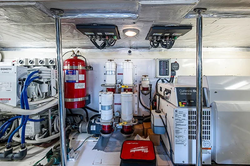 Slide: The Image of Engine room of 2009 Riviera 58 Flybridge with Cummins Onan generator and fire extinguisher. - 53