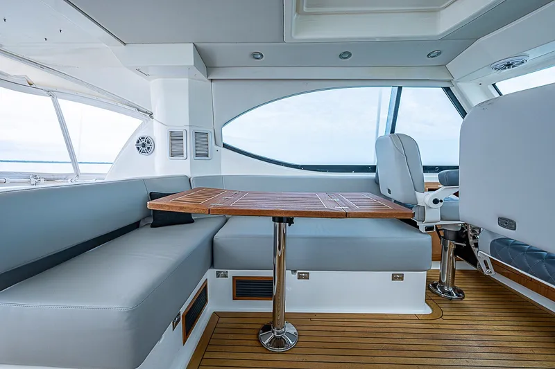 Slide: The Image of Luxurious interior of 2009 Riviera 58 Flybridge yacht with elegant seating and wooden table. - 63