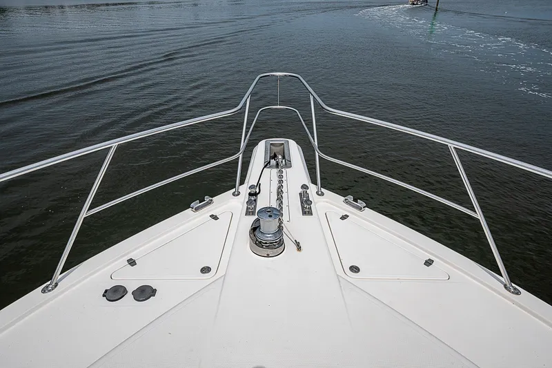 Slide: The Image of Bow view of 2009 Riviera 58 Flybridge yacht on calm water. - 85