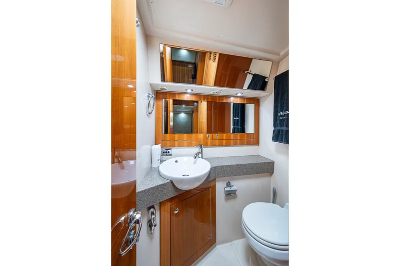 Slide: The Image of Luxurious bathroom in 2009 Riviera 58 Flybridge yacht with modern fixtures and wood accents. - 43