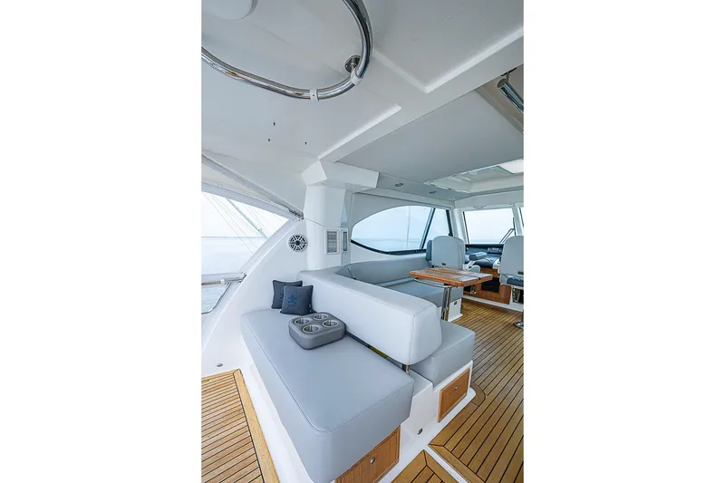 Slide: The Image of Luxurious interior of 2009 Riviera 58 Flybridge yacht with elegant seating and wooden flooring. - 64
