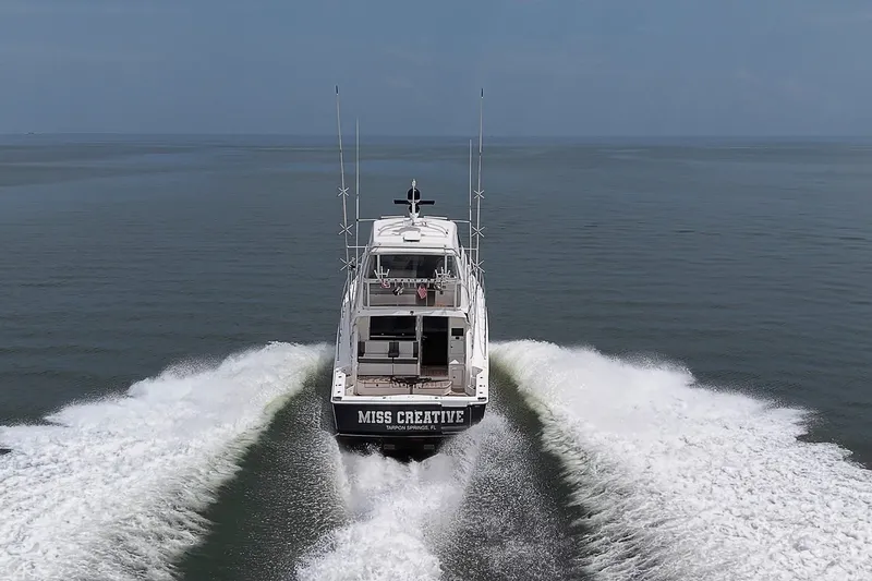 Slide: The Image of Riviera 58 Flybridge yacht cruising on open water, rear view, 2009 model. - 108