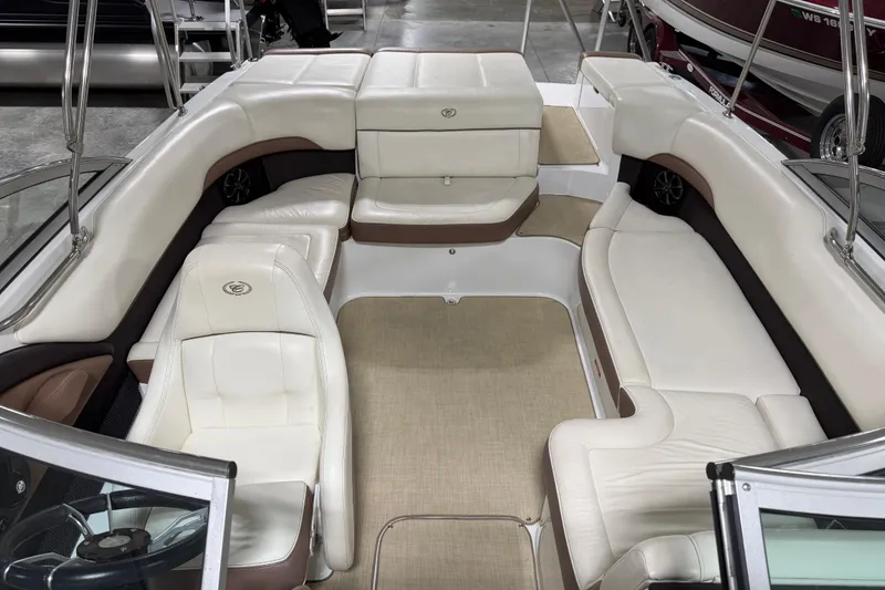 Slide: The Image of 2013 Cobalt 220 boat interior with white leather seating and beige flooring. - 12