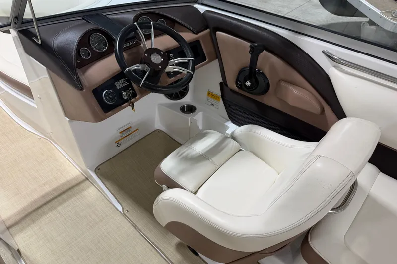 Slide: The Image of Interior of 2013 Cobalt 220 boat, featuring steering wheel and comfortable seating. - 8