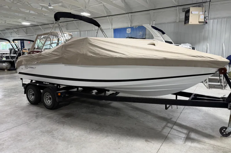 Slide: The Image of 2013 Cobalt 220 boat with cover on trailer in indoor storage facility. - 17