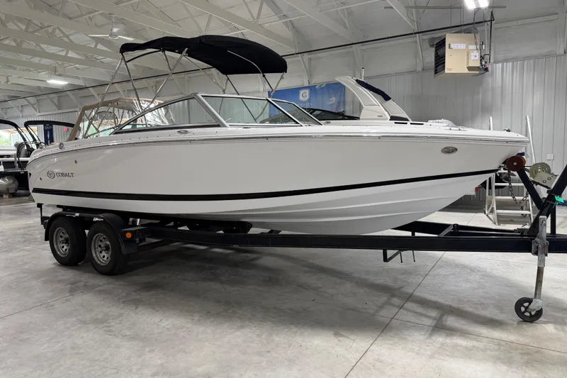 Slide: The Image of 2013 Cobalt 220 boat on trailer in indoor showroom setting. - 3