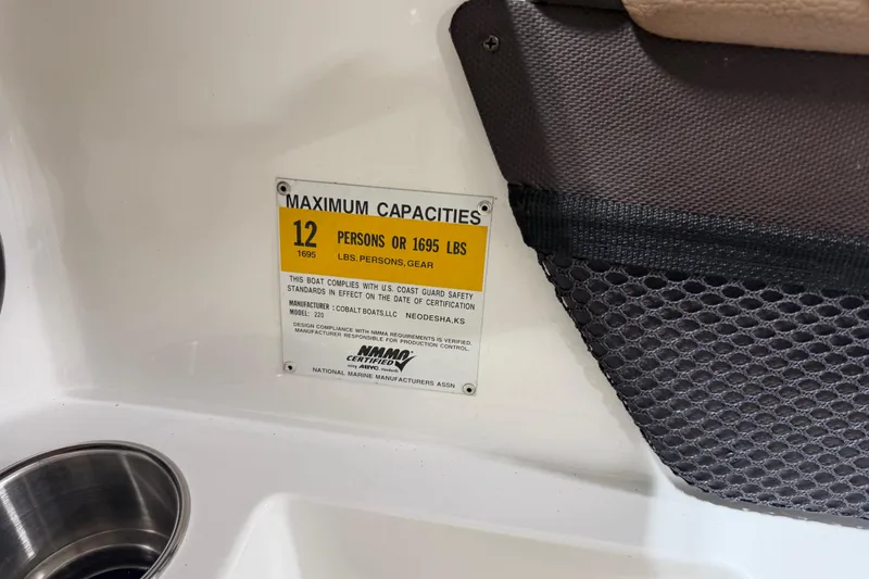 Slide: The Image of Capacity label on 2013 Cobalt 220 boat, max 12 persons or 1695 lbs. - 9