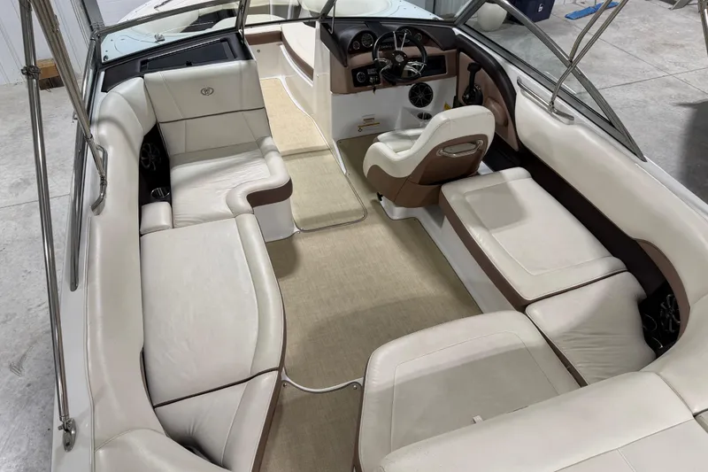 Slide: The Image of Interior of a 2013 Cobalt 220 boat with white and brown seating. - 6