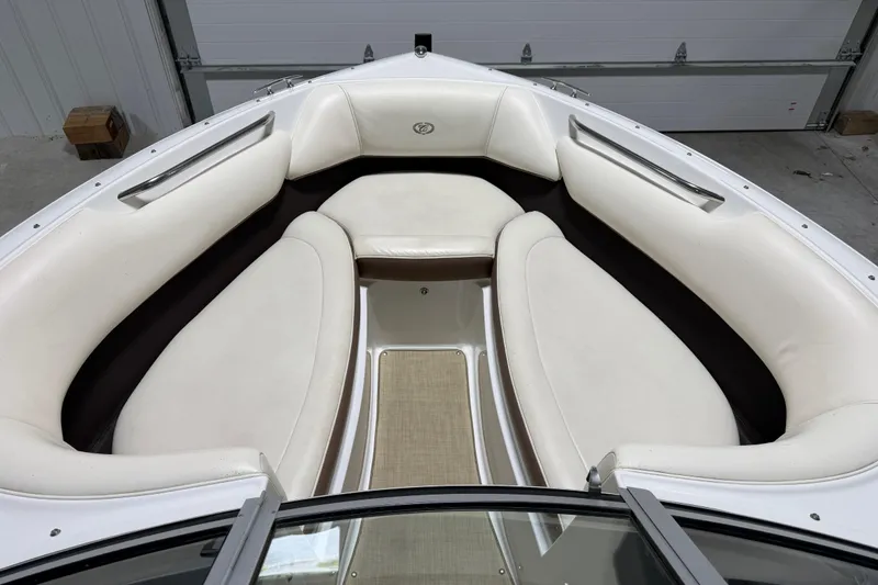 Slide: The Image of Interior view of a 2013 Cobalt 220 boat with white cushioned seating. - 11