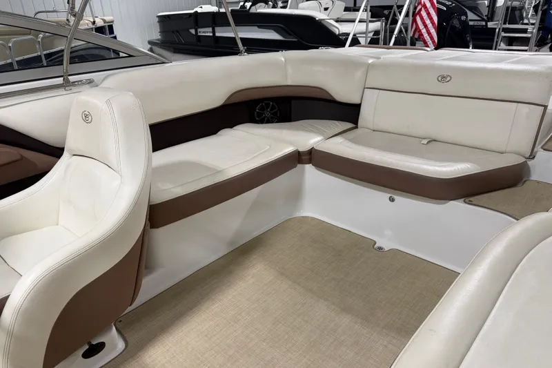 Slide: The Image of Interior of a 2013 Cobalt 220 boat with white and brown seating. - 7