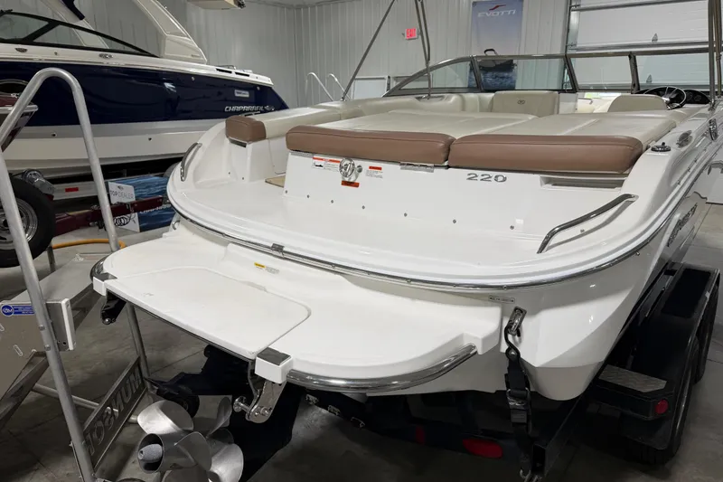 Slide: The Image of 2013 Cobalt 220 boat in showroom, featuring sleek design and comfortable seating. - 5