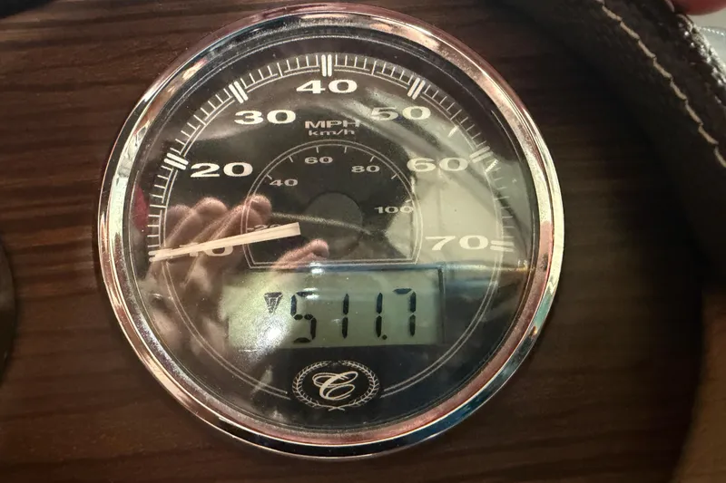 Slide: The Image of Speedometer of 2013 Cobalt 220 boat showing 51.7 MPH on wooden dashboard. - 18