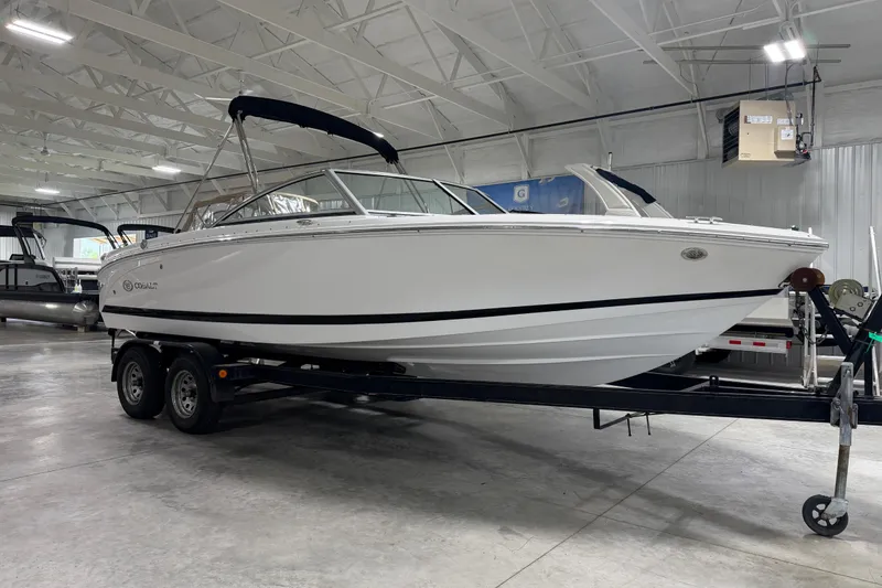 Slide: The Image of 2013 Cobalt 220 boat on trailer in indoor showroom setting. - 14