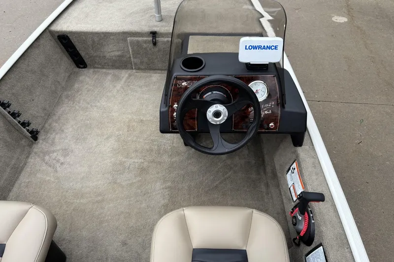 Slide: The Image of 2022 Tracker Bass Tracker Classic XL boat interior with steering wheel and Lowrance device. - 8