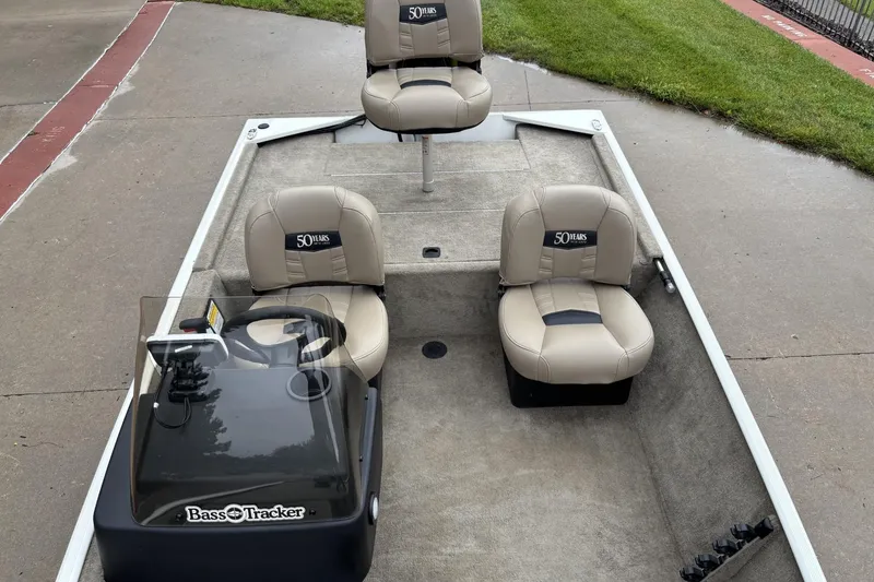 Slide: The Image of 2022 Tracker Bass Tracker Classic XL boat interior with beige seats and steering console. - 7