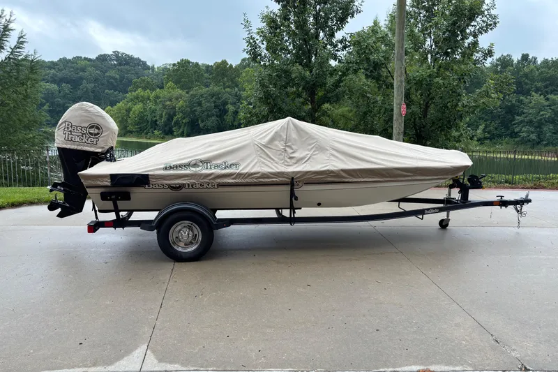Slide: The Image of 2022 Tracker Bass Tracker Classic XL boat covered on trailer, parked outdoors. - 5