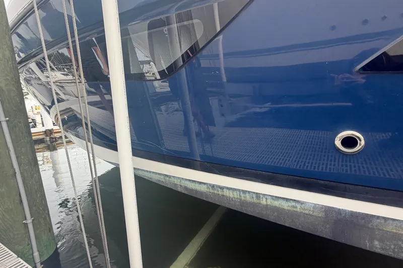 Slide: The Image of A 2017 Regal 32 Express boat docked. The hull is blue. - 36