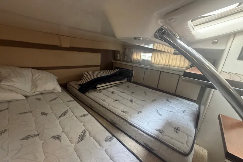 Slide: The Image of 2017 Regal 32 Express cabin interior with twin beds and natural light. - 19