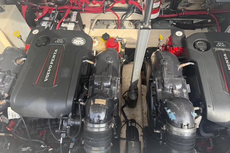 Slide: The Image of Two Volvo Penta engines in a 2017 Regal 32 Express boat, with red and black wiring. - 33