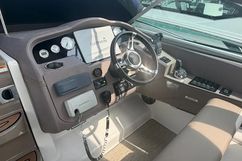 Slide: The Image of Cockpit of 2017 Regal 32 Express boat with Garmin navigation system and controls. - 8