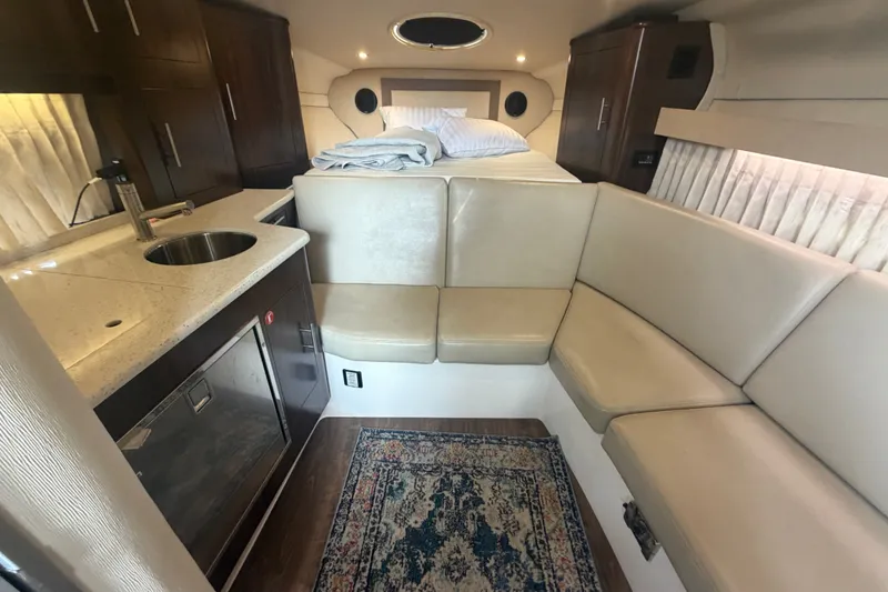 Slide: The Image of Interior of 2017 Regal 32 Express yacht with kitchenette, seating, and bed. - 12