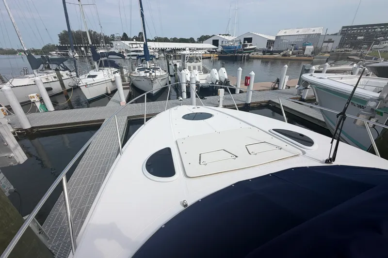 Slide: The Image of 2017 Regal 32 Express yacht docked at marina with surrounding boats. - 26
