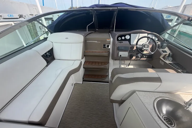 Slide: The Image of 2017 Regal 32 Express boat interior with helm, seating, and sink. - 4