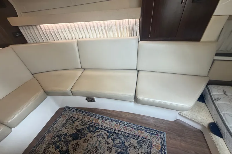 Slide: The Image of Interior of 2017 Regal 32 Express with beige seating and decorative rug. - 15