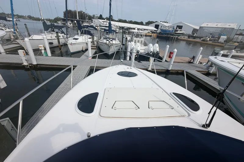 Slide: The Image of 2017 Regal 32 Express yacht docked at marina, surrounded by other boats. - 25