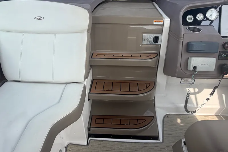 Slide: The Image of Interior of a 2017 Regal 32 Express boat with seating and control panel. - 11