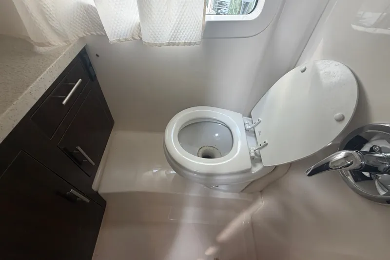 Slide: The Image of Bathroom interior of 2017 Regal 32 Express boat with toilet and cabinetry. - 23