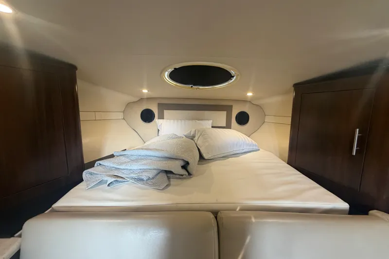 Slide: The Image of Cozy cabin interior of 2017 Regal 32 Express yacht with bed and storage cabinets. - 14