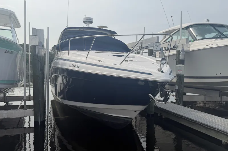 Slide: The Image of 2017 Regal 32 Express boat docked at marina, front view. - 0