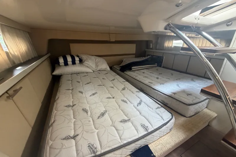 Slide: The Image of Interior cabin of 2017 Regal 32 Express yacht with twin beds and nautical decor. - 17